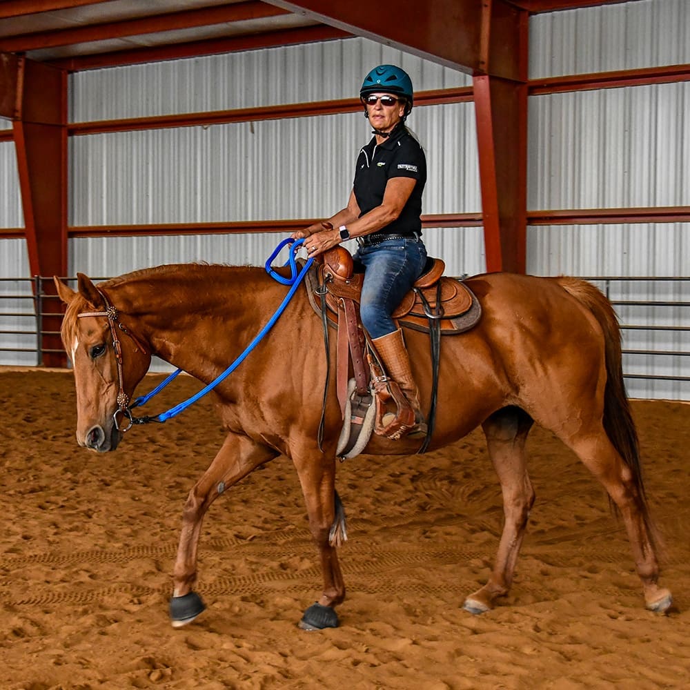 Julie riding Truth in a Western saddle